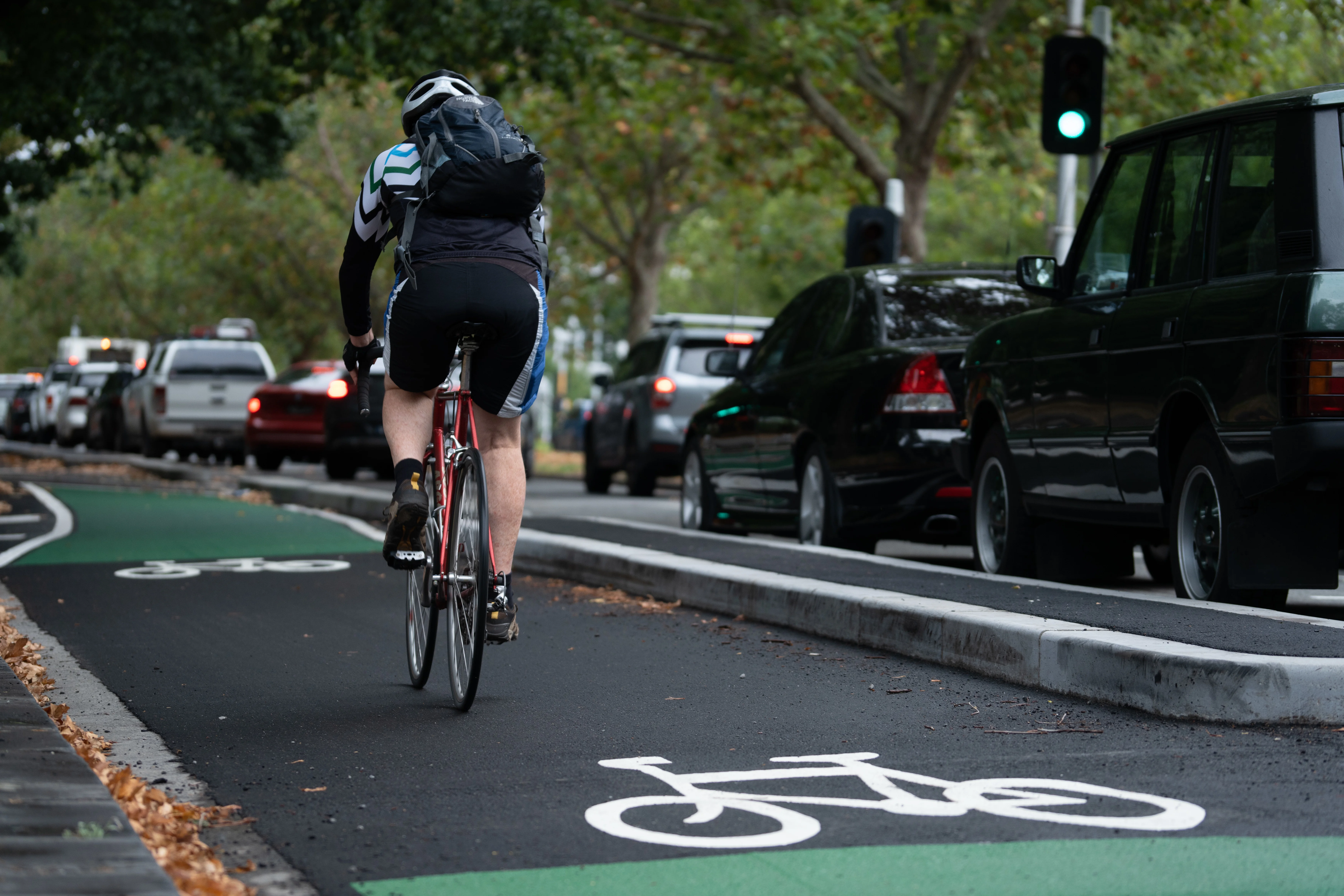 Cyclist riding in a protected bike lane on St Kilda Road